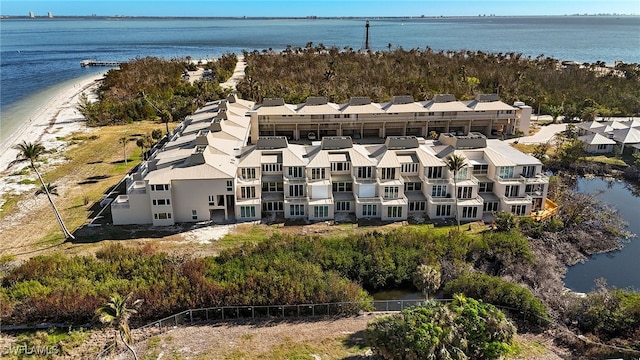 drone / aerial view featuring a water view and a view of the beach