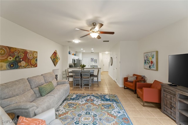 living room featuring light tile patterned floors and ceiling fan