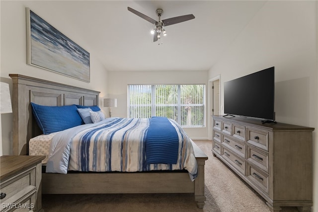 bedroom with vaulted ceiling, ceiling fan, and light colored carpet