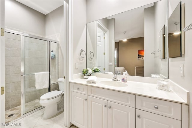 bathroom with vanity, toilet, walk in shower, and tile patterned floors