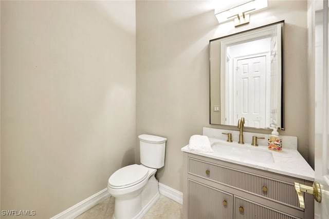 bathroom with vanity, toilet, and tile patterned flooring