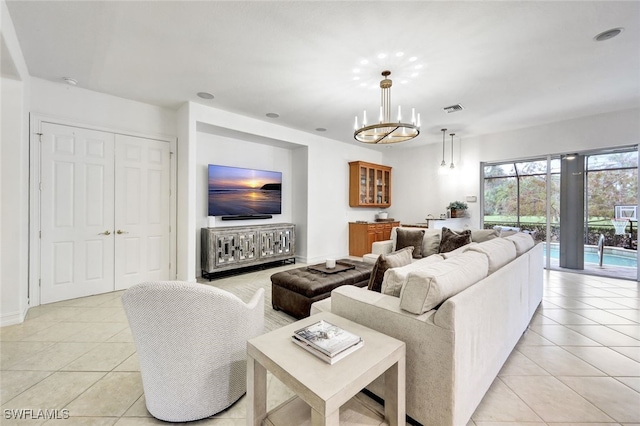 living room with a chandelier and light tile patterned floors