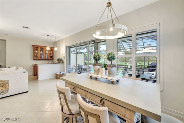 tiled dining space featuring an inviting chandelier