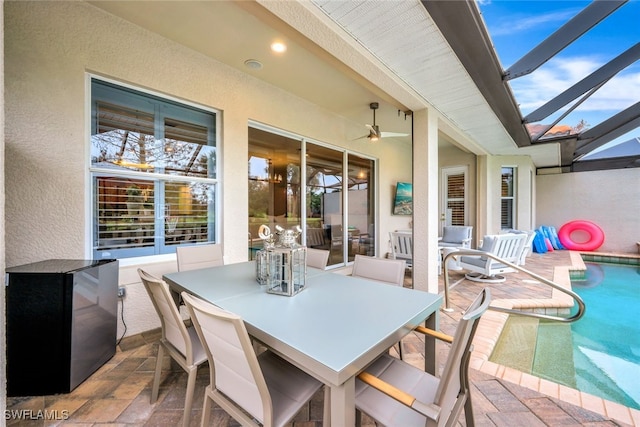 view of patio featuring ceiling fan and a lanai