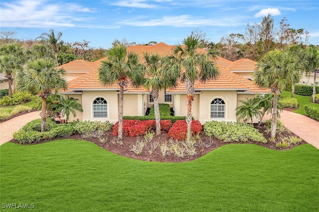 mediterranean / spanish-style house featuring a front yard