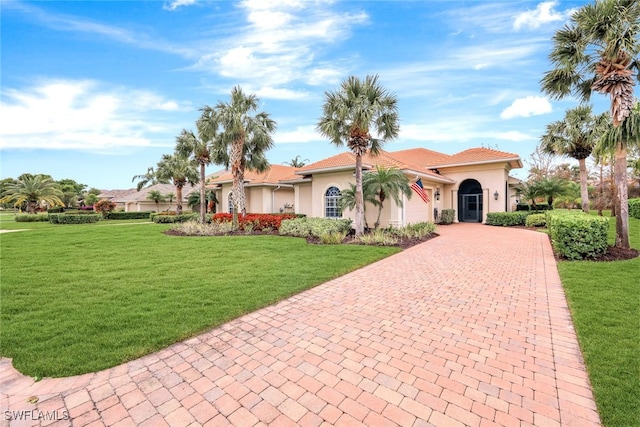 view of front of property featuring a garage and a front yard