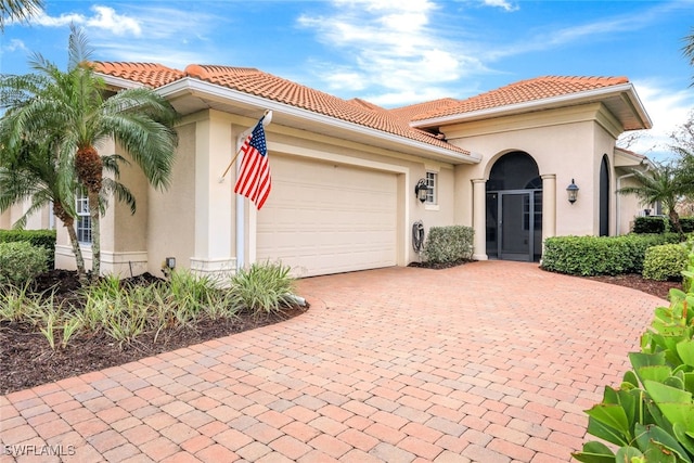 mediterranean / spanish-style house with a garage