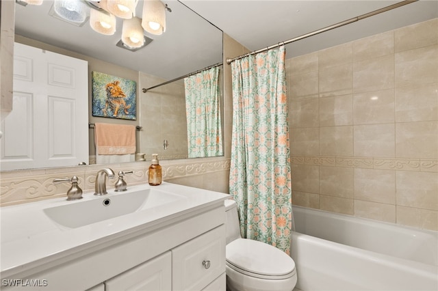 full bathroom featuring toilet, tile walls, vanity, and shower / bath combo with shower curtain