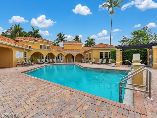 view of swimming pool featuring a patio and a pergola