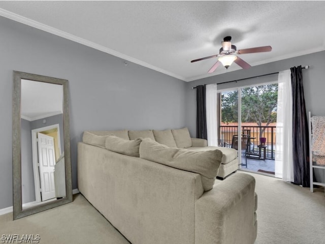 living room with a textured ceiling, ceiling fan, crown molding, and light colored carpet