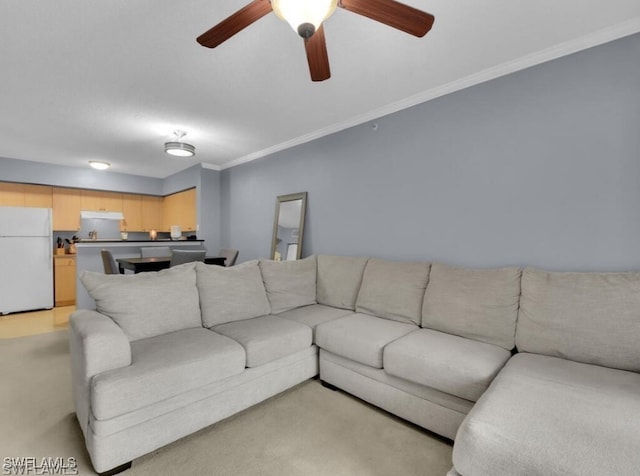 living room with ceiling fan and crown molding