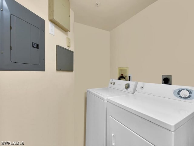 washroom with electric panel and washing machine and clothes dryer