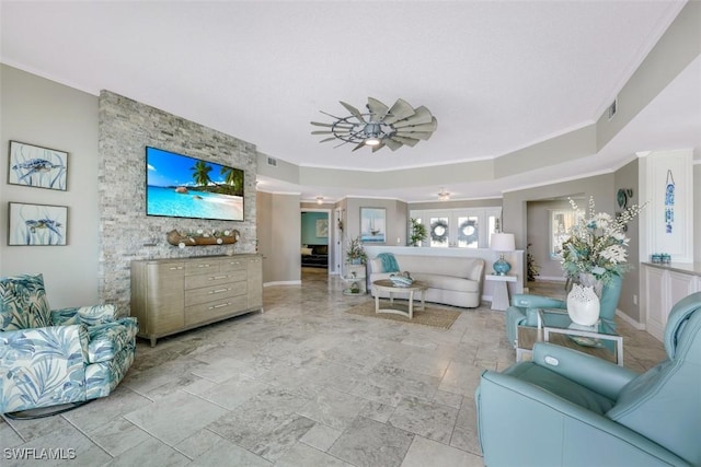 living room featuring ceiling fan and ornamental molding