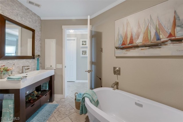 bathroom featuring tile patterned flooring, vanity, a tub, and crown molding