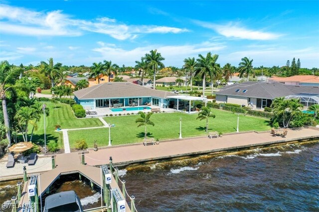 rear view of property with a water view