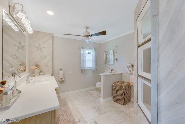 bathroom with toilet, vanity, ceiling fan, and crown molding