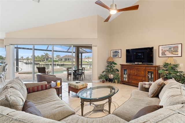 living room featuring ceiling fan, high vaulted ceiling, and light tile patterned flooring