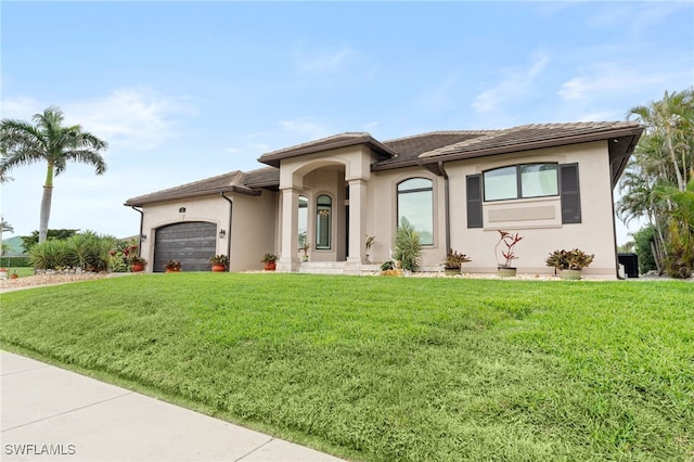 view of front of house with a garage and a front yard