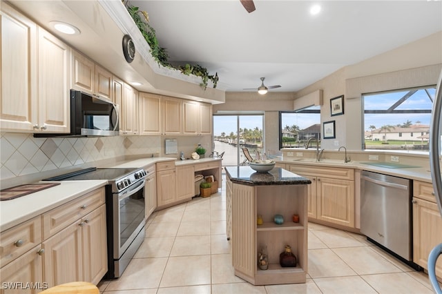 kitchen featuring decorative backsplash, sink, light brown cabinetry, and appliances with stainless steel finishes