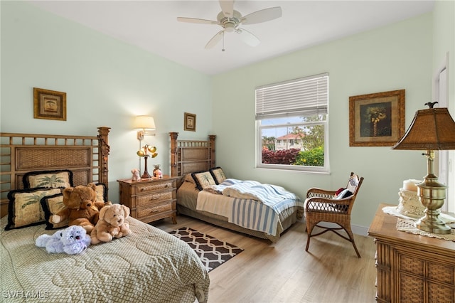 bedroom with ceiling fan and light hardwood / wood-style flooring