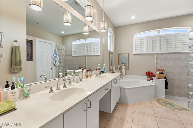 bathroom featuring shower with separate bathtub, vanity, and tile patterned flooring