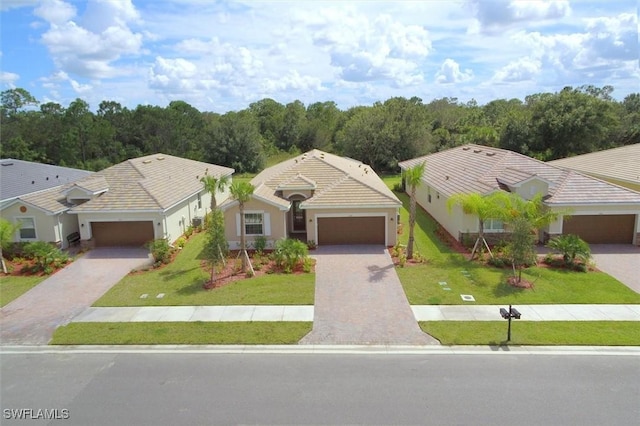 view of front facade with a garage and a front lawn