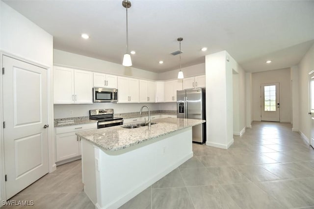 kitchen featuring white cabinets, stainless steel appliances, sink, hanging light fixtures, and light stone counters