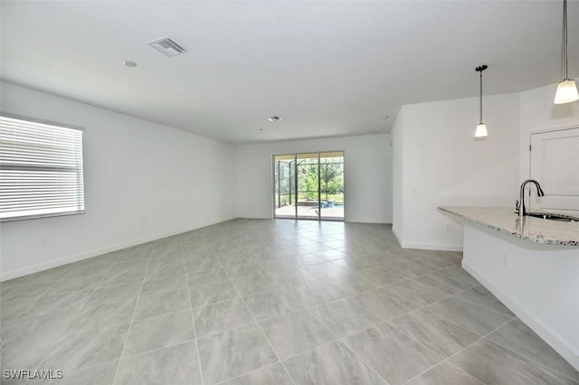 unfurnished living room with sink