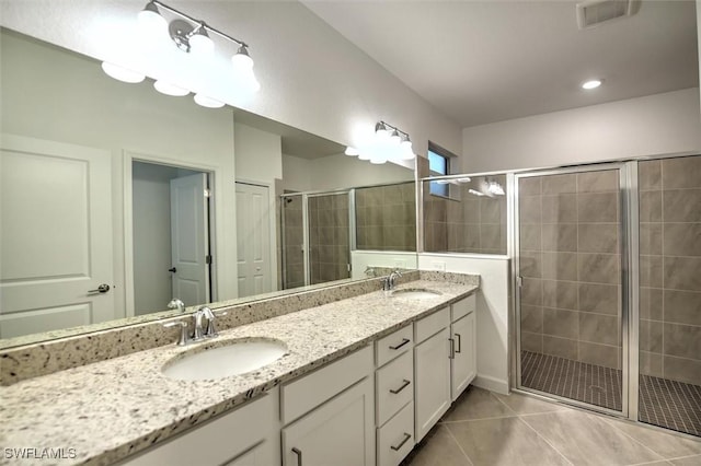 bathroom featuring an enclosed shower, vanity, and tile patterned flooring