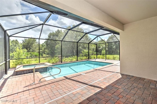 view of pool featuring an in ground hot tub, a lanai, and a patio