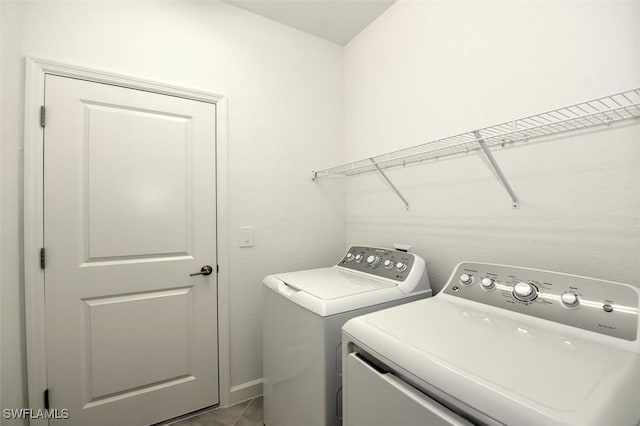 washroom featuring tile patterned floors and separate washer and dryer