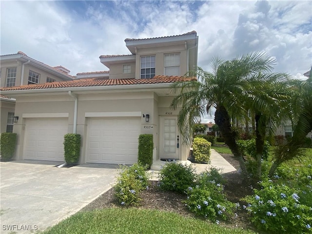 3054 Driftwood Way Unit 4508, Naples, FL 34109 - view of front facade with concrete driveway, stucco siding, an attached garage, and a tiled roof