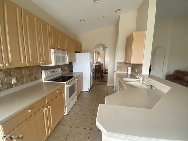3054 Driftwood Way Unit 4508, Naples, FL 34109 - kitchen with white appliances, light tile patterned floors, tasteful backsplash, light brown cabinets, and arched walkways