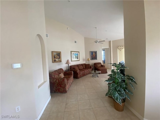 3054 Driftwood Way Unit 4508, Naples, FL 34109 - living room featuring arched walkways, light tile patterned flooring, ceiling fan, and high vaulted ceiling