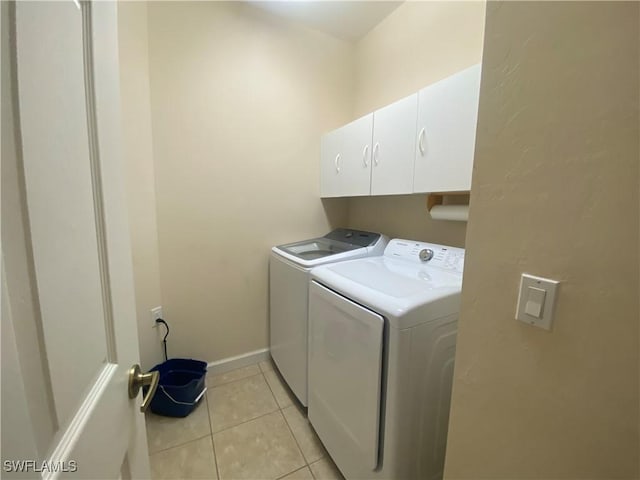3054 Driftwood Way Unit 4508, Naples, FL 34109 - washroom featuring washer and dryer, cabinet space, and light tile patterned flooring