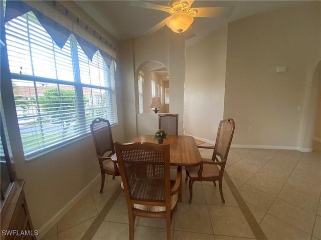 3054 Driftwood Way Unit 4508, Naples, FL 34109 - dining space featuring light tile patterned floors, arched walkways, and a ceiling fan