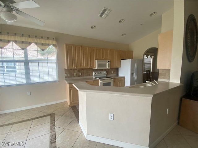 3054 Driftwood Way Unit 4508, Naples, FL 34109 - kitchen featuring white appliances, arched walkways, a ceiling fan, decorative backsplash, and recessed lighting