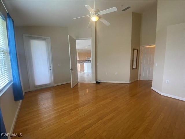 3054 Driftwood Way Unit 4508, Naples, FL 34109 - unfurnished room featuring high vaulted ceiling, light wood-style floors, ceiling fan, and healthy amount of natural light