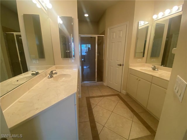 3054 Driftwood Way Unit 4508, Naples, FL 34109 - full bathroom with tile patterned floors, a shower stall, two vanities, and inlaid floor details