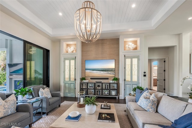 living room featuring a notable chandelier, wooden ceiling, light hardwood / wood-style floors, and a tray ceiling