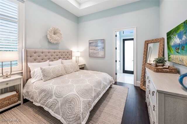 bedroom with dark wood-type flooring