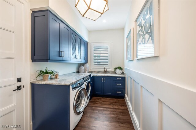 laundry area featuring cabinets, dark hardwood / wood-style flooring, washer and clothes dryer, and sink