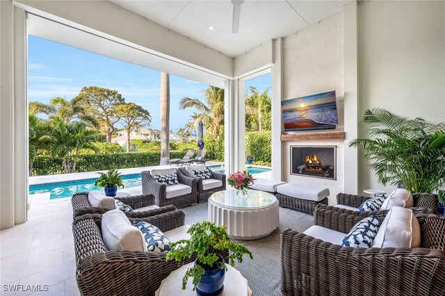 view of patio / terrace with an outdoor living space with a fireplace