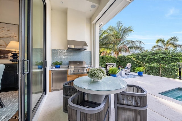 view of patio with an outdoor kitchen and area for grilling