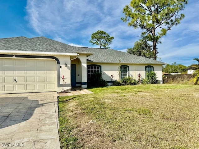 single story home with a garage and a front lawn