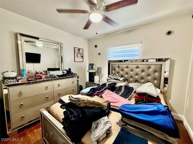 bedroom with ceiling fan and dark hardwood / wood-style floors