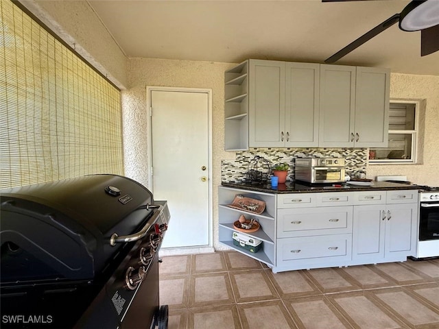 kitchen with tasteful backsplash and white cabinetry