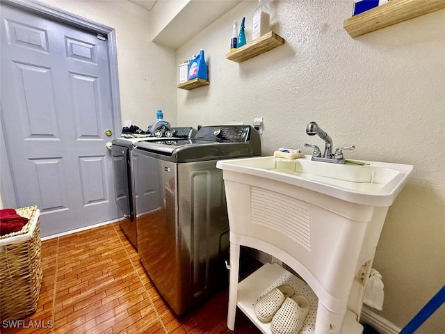 laundry room featuring sink and washer and clothes dryer