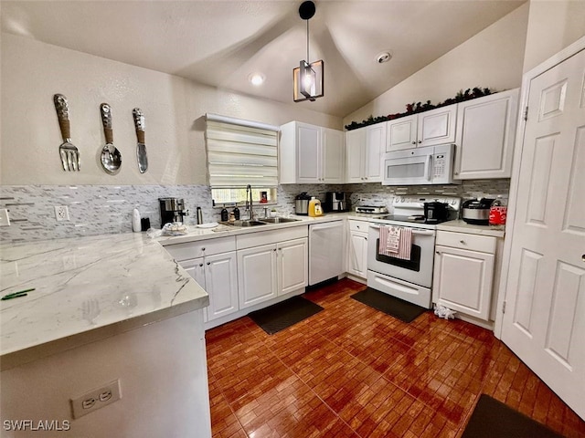 kitchen with decorative light fixtures, lofted ceiling, sink, white appliances, and white cabinetry