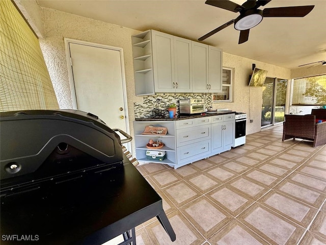 kitchen with white cabinets and tasteful backsplash